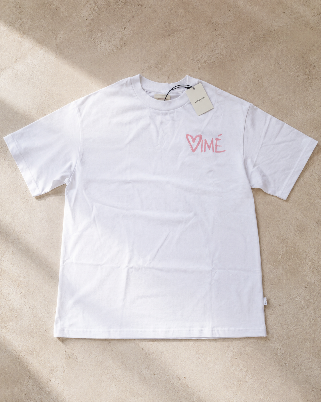 Aime Leon Dore White Back-Print T-Shirt with Peach Hand‑Lettered Graphic — vintage back-print tee
