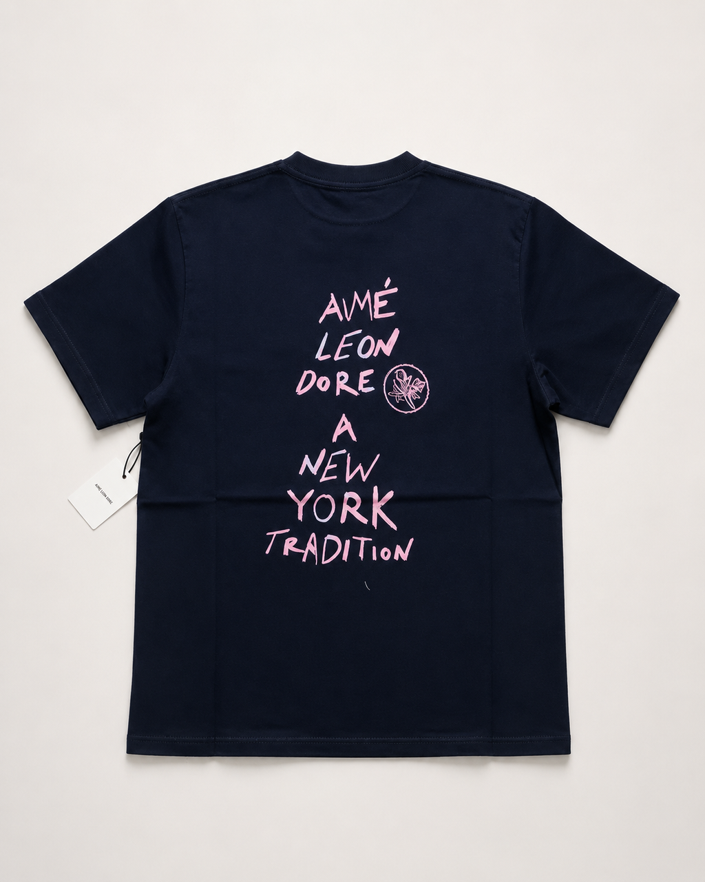 Aime Leon Dore White Back-Print T-Shirt with Peach Hand‑Lettered Graphic — vintage back-print tee