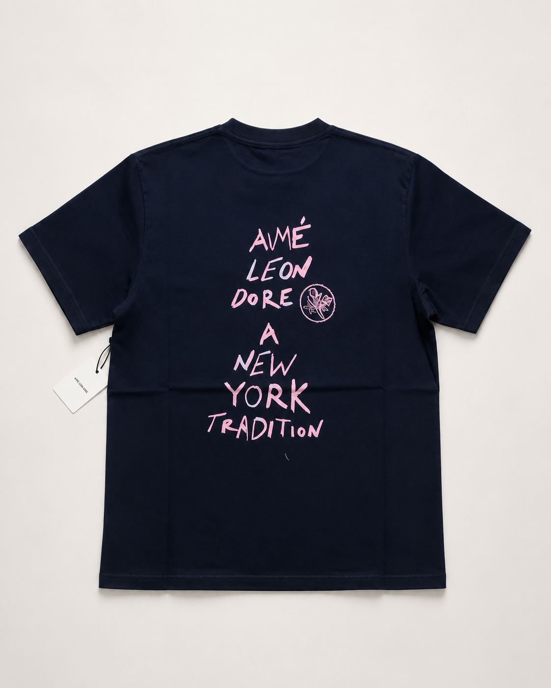 Aime Leon Dore White Back-Print T-Shirt with Peach Hand‑Lettered Graphic — vintage back-print tee